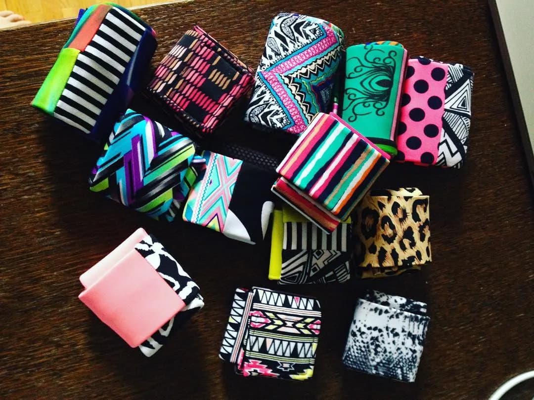 A table covered in SneakyDeez wrist wraps, every pair a different design